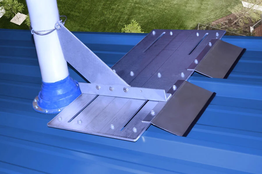 Screw-down VentSaver mounting plate and snow-diversion assembly installed beside a vent pipe