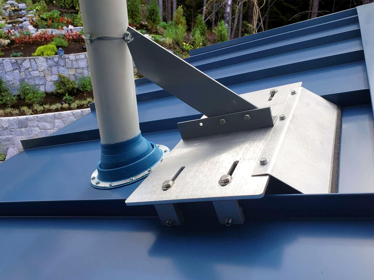 VentSaver vent protection system installed beside a vent pipe on a standing seam metal roof
